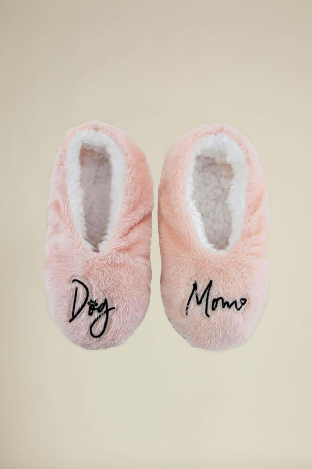 Pink plush footsies slippers laid flat, with 'Dog' and 'Momo' on the toe
