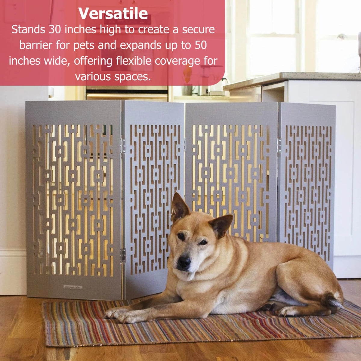 Gray freestanding indoor dog gate with geometric lattice panels, set up in doorway