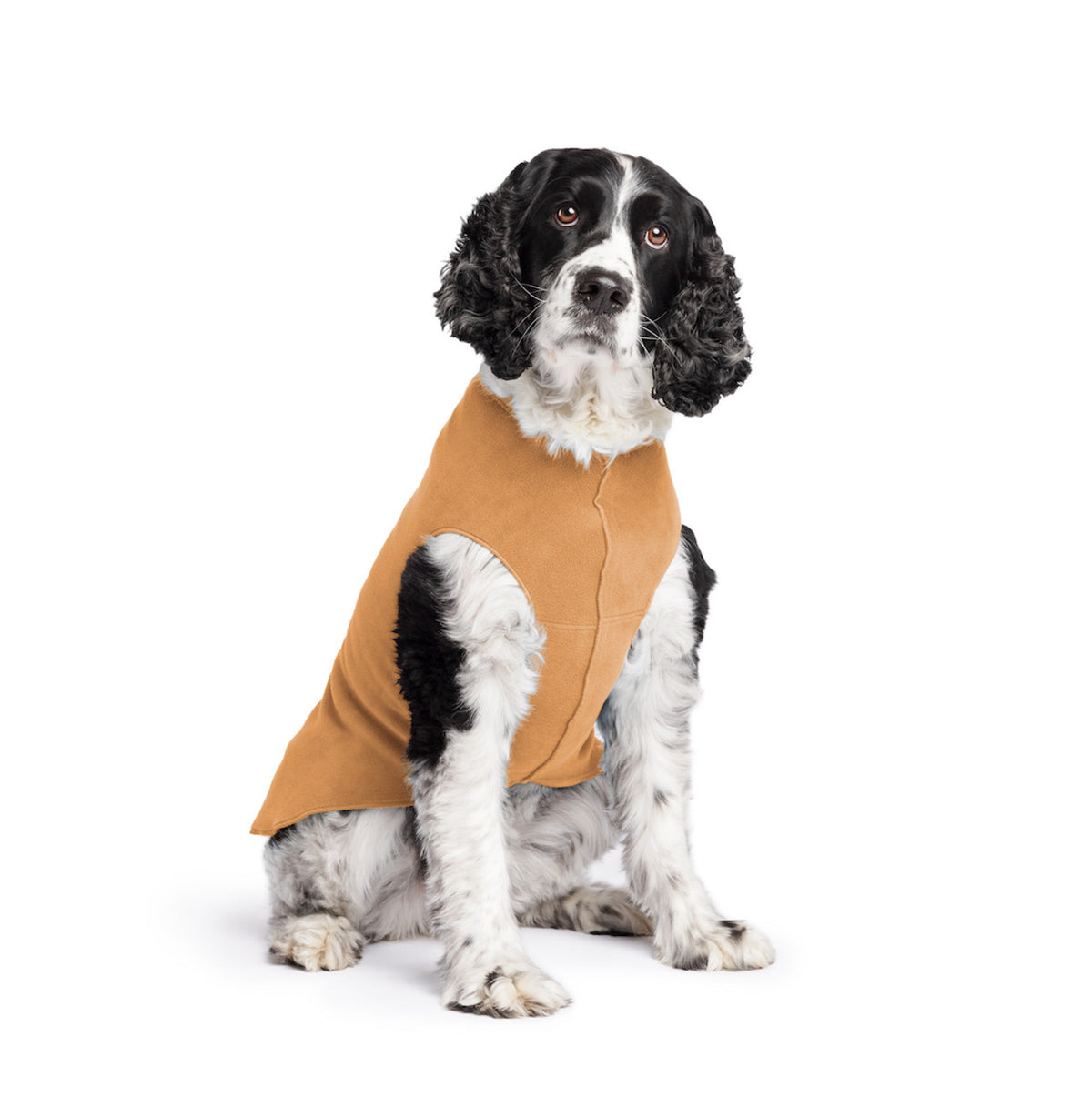 Tan stretch fleece dog coat with arm cutout and chest seam, worn by black-and-white dog