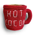 Red crochet hot cocoa mug dog toy with white stitched cocoa pattern and handle