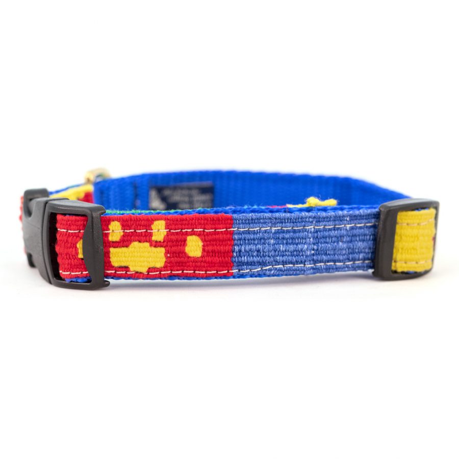 Handmade cotton dog collar with blue woven strap, red paw print band, and plastic buckle