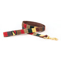Handmade cotton dog leash with woven red, green, and cream pattern; brass clasp