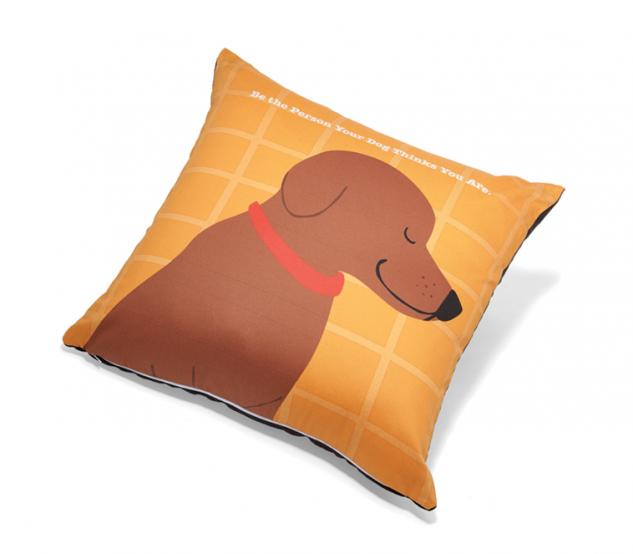 Orange throw pillow with cartoon dog graphic and red collar