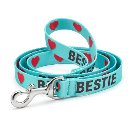 Teal dog collar with red hearts and "BESTIE" text, metal D-ring and clasp