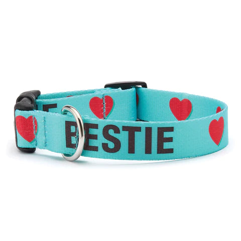 Teal dog collar with red hearts, "BESTIE" lettering and metal buckle, side view