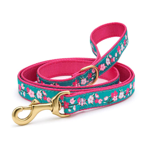 Pink dog collar and matching leash with teal cherry blossom pattern and gold clips