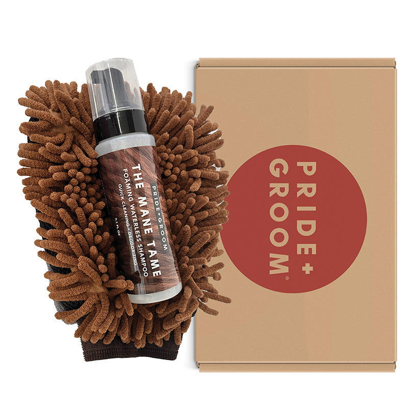 Brown dog grooming mitt with waterless grooming bottle beside a cardboard kit box