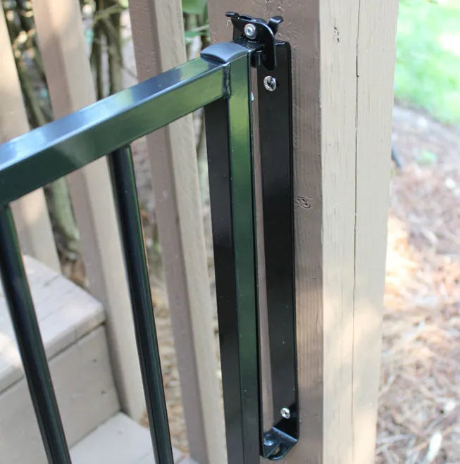 Aluminum safety gate latch and hinge hardware on a wooden post