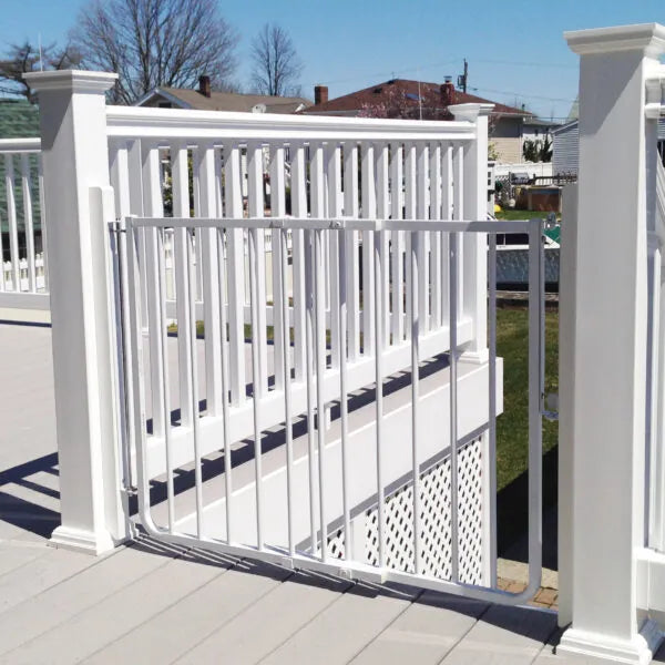 White aluminum safety gate attached to exterior porch railing with vertical bars