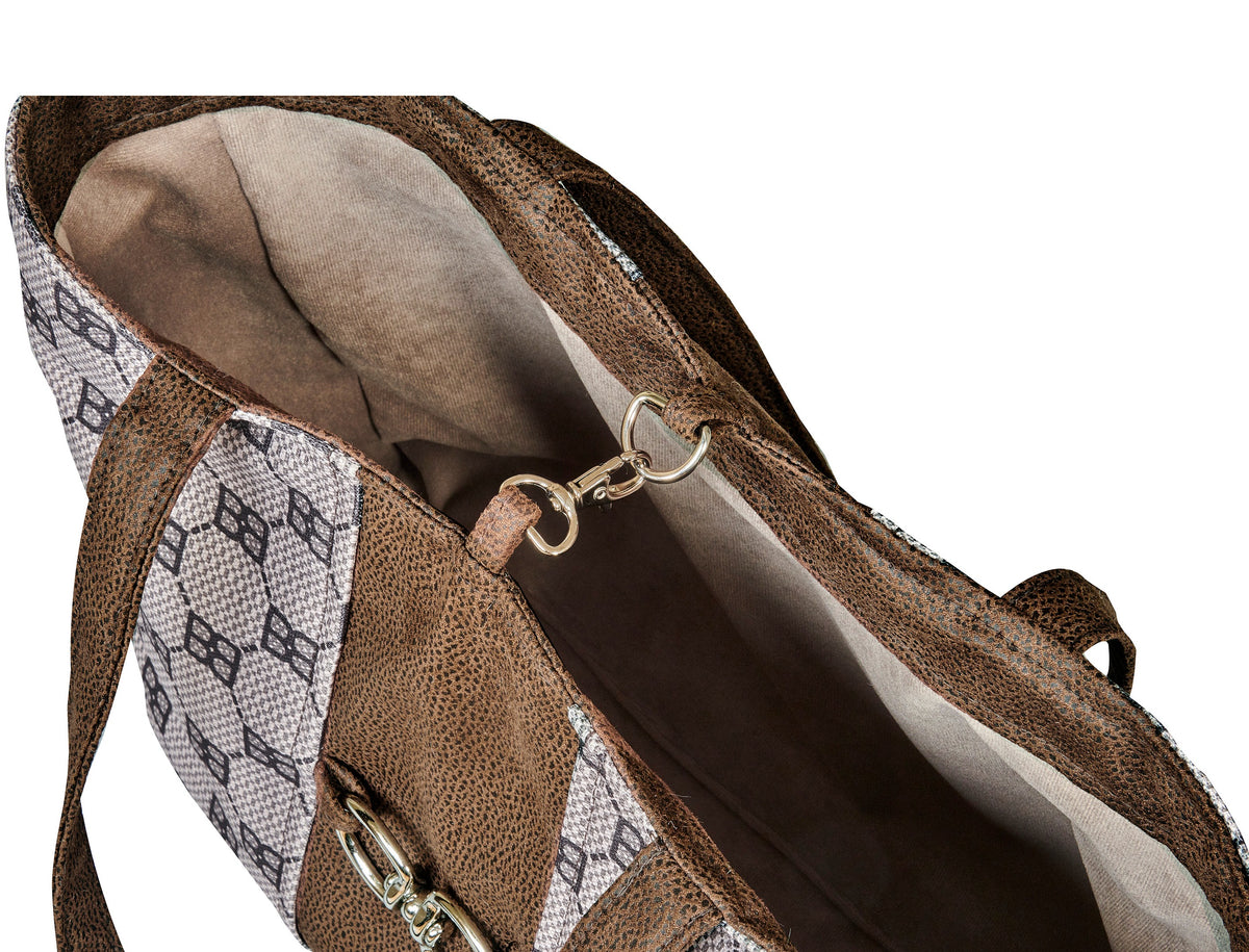Dog carrier tote side view with brown trim, two metal rings, and fabric lining