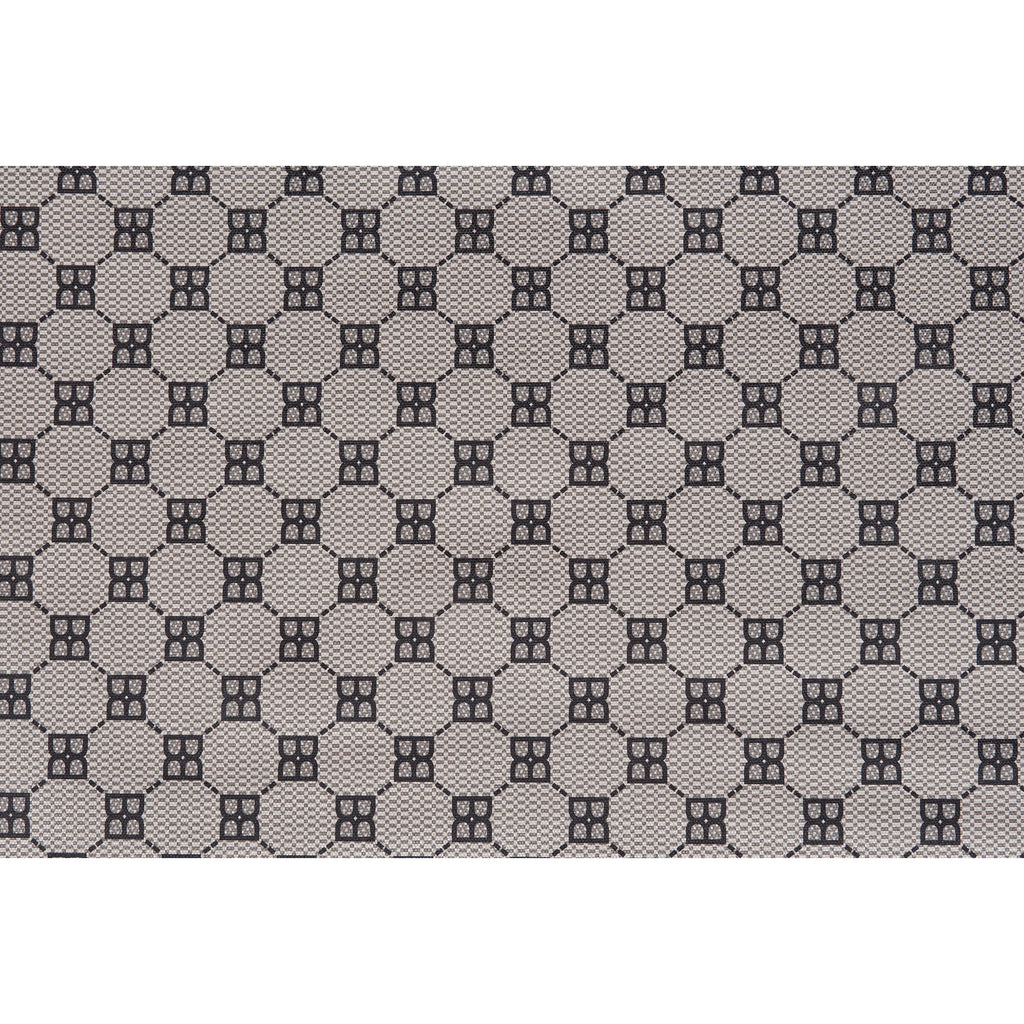 Close-up of gray patterned fabric with repeating geometric monogram icons
