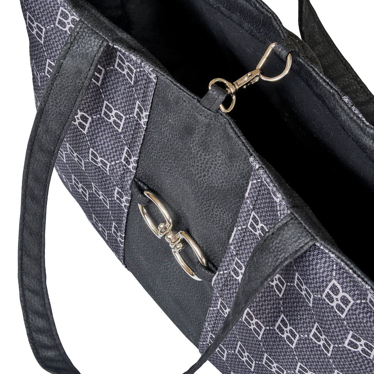 Close-up of dark signature-pattern dog carrier tote inner panel and metal latch hardware