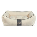 Ivory faux sheepskin scoop dog bed with dark trim and front buckle detail