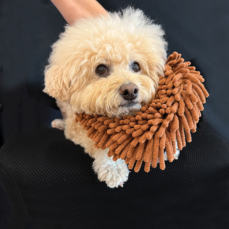 Dog wearing a brown, shaggy waterless grooming mitt with gray fabric backing