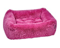 Pink plush dog bed with padded bolster sides and cushioned interior, rectangular shape