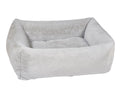 Light gray fabric dog bed with thick cushioned sides and inner bolster