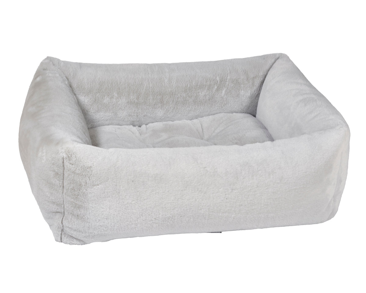 Light gray fabric dog bed with thick cushioned sides and inner bolster