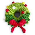 Crochet dog toy shaped as a green Christmas wreath with red bow and colorful accents