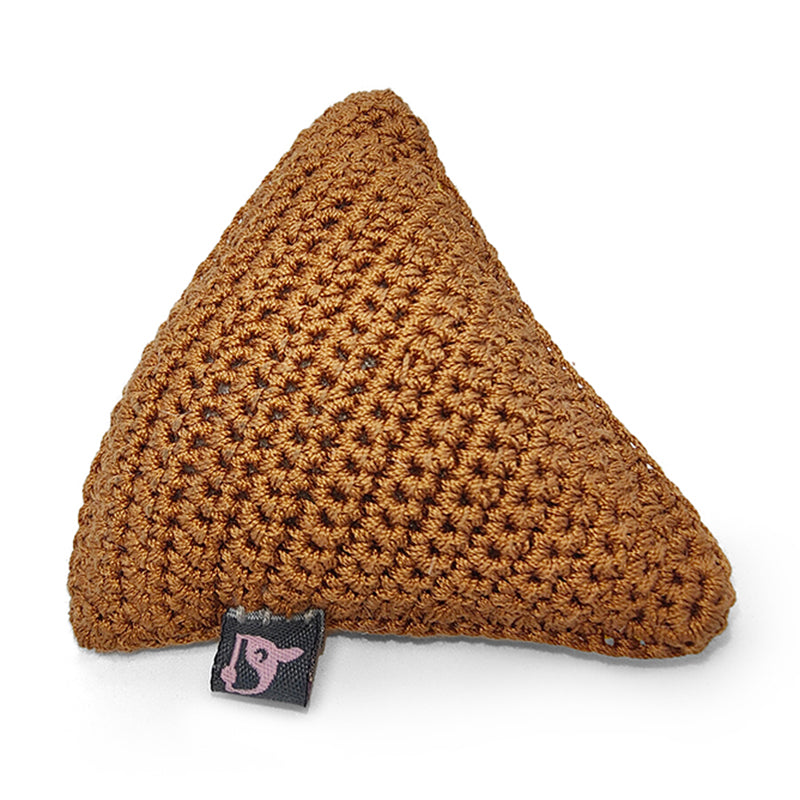Crocheted brown triangular dog toy with fabric label at the bottom