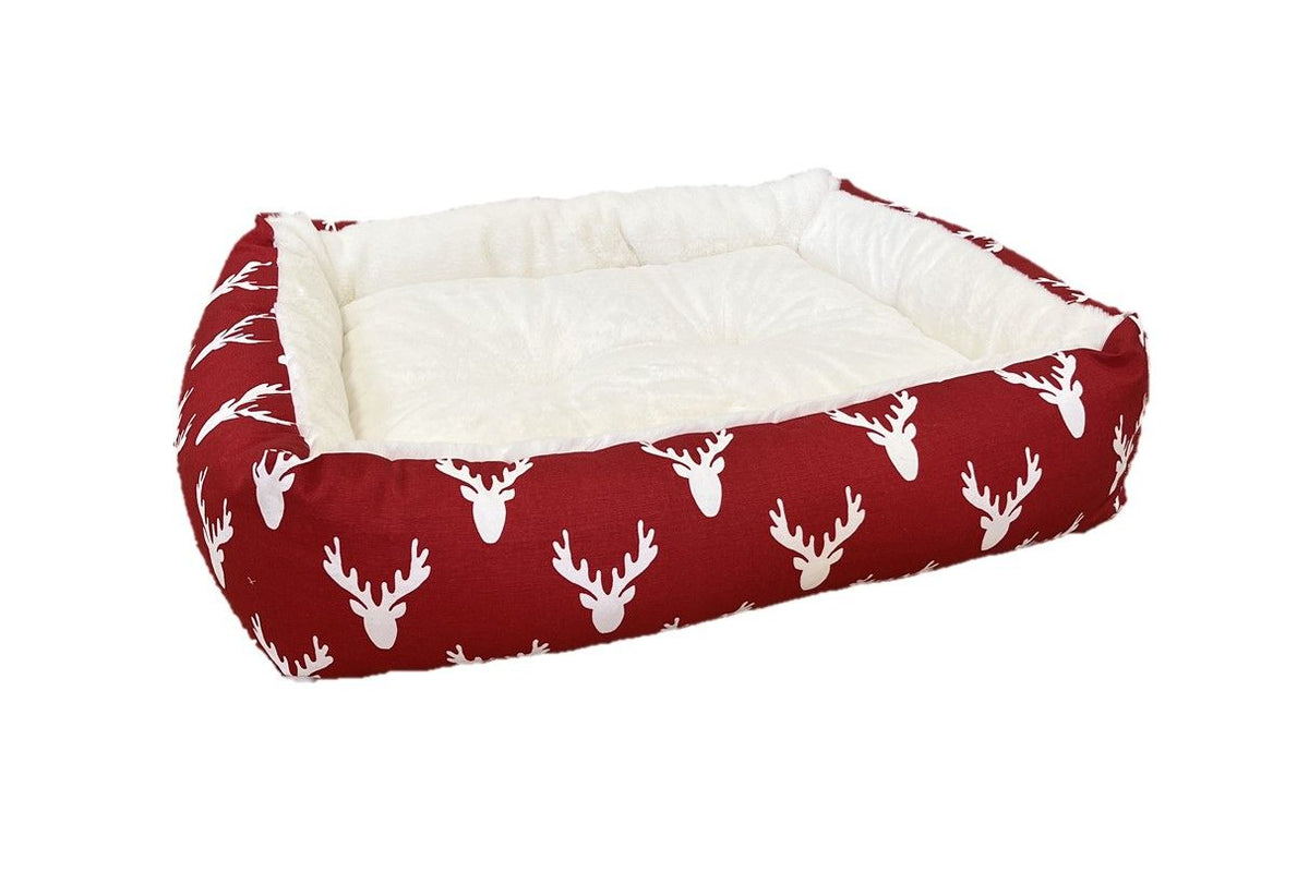 Red and white antler-print dog lounger bed with cushioned rectangular base
