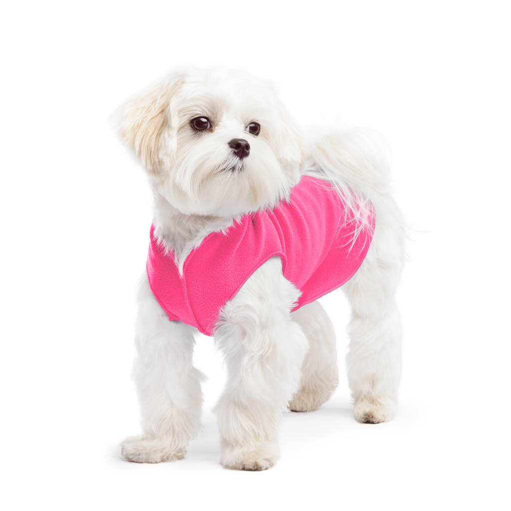 Hot pink stretch fleece dog coat with V-neck, worn by a white long-haired dog