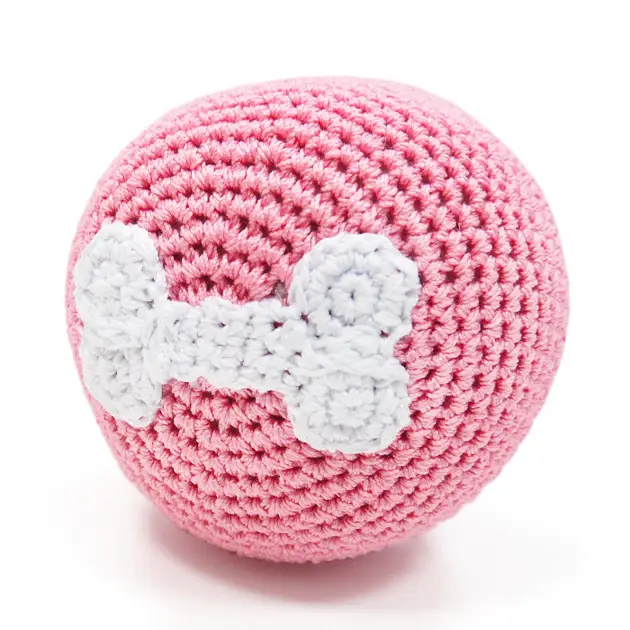 Pink crocheted dog toy ball with raised white bone detail
