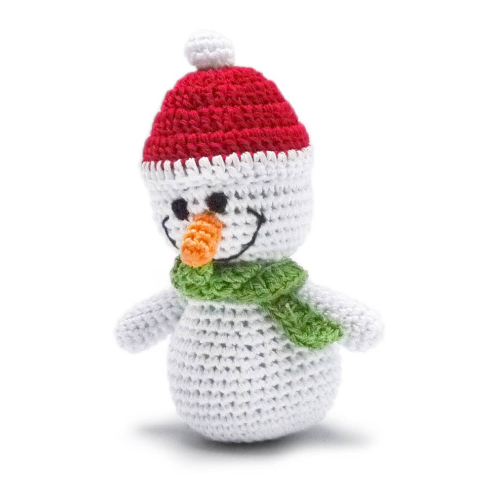 Crochet snowman dog toy with red hat and green scarf, orange nose detail