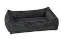 Dark gray woven dog bed with raised bolsters and rectangular cushion