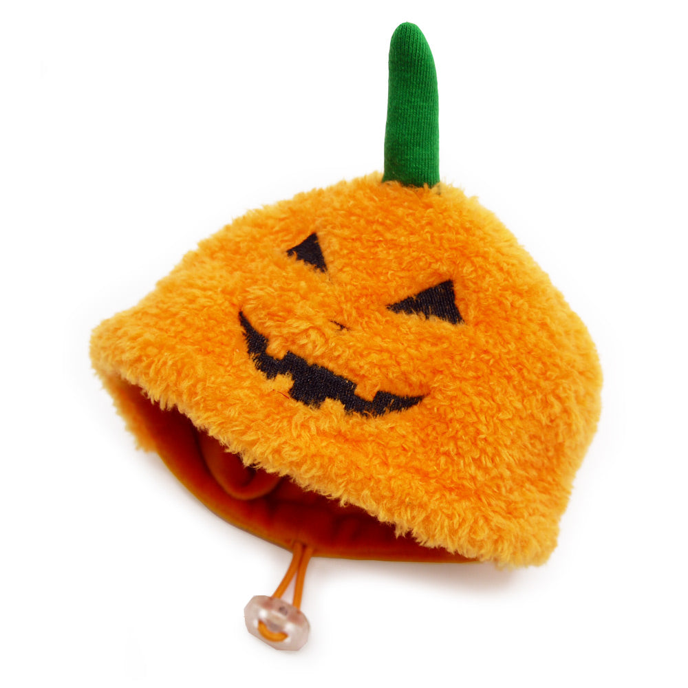 Orange plush dog pumpkin hat with green stem and jack-o-lantern face, chin strap
