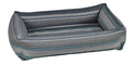 Striped fabric dog lounger bed with gray base, teal trim, and open bolstered sides