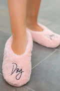 Pink fuzzy slip-on footsies slipper with embroidered 'Dog' logo on the toe