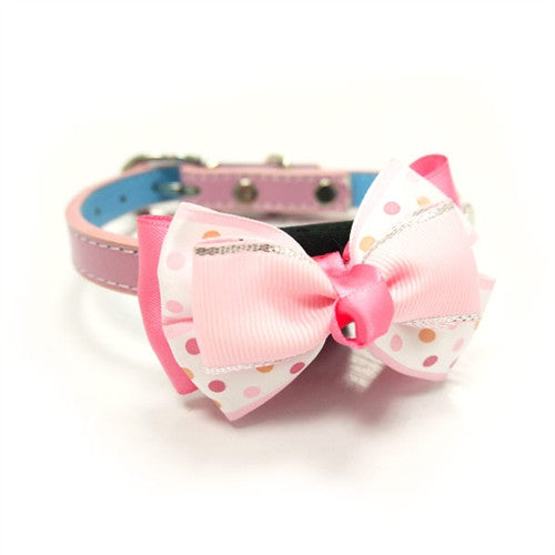 Pink polka-dot dog bow tie attached to a pink collar strap