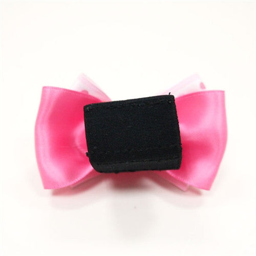 Pink dog bow tie with black clip backing and layered polka-dot tails