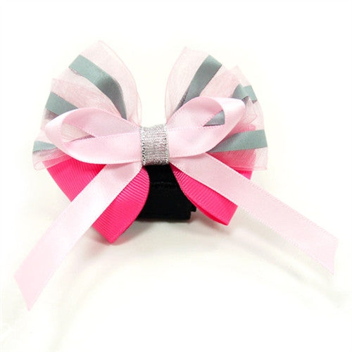 Dog bow tie with layered pink ribbons, pastel stripes, and black center