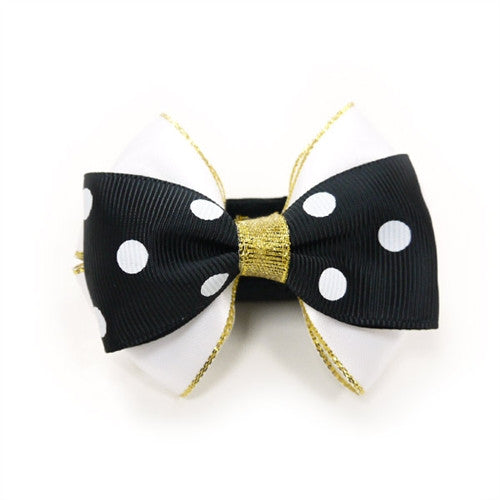 Black polka-dot dog bow tie with gold ribbon center and gold hanging threads