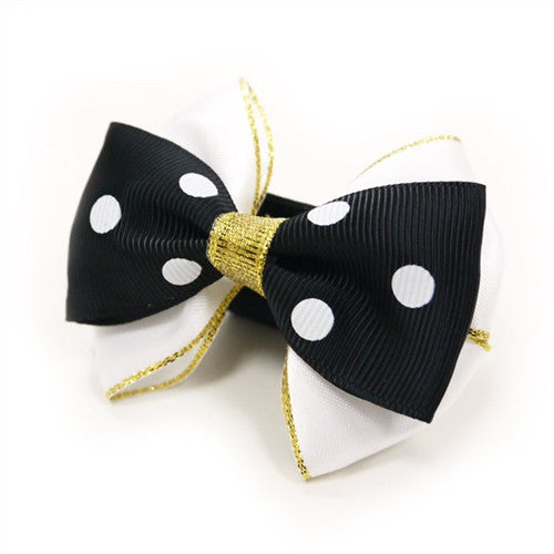 Black polka-dot dog bow tie with glittery gold center and dangling gold threads