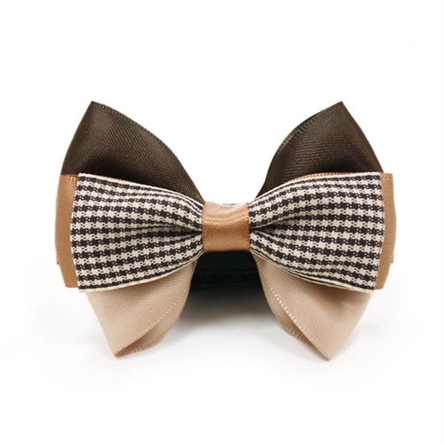 Dog bow tie: brown wings with black-and-white houndstooth stripe and tan center knot