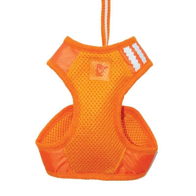 Orange soft step-in dog harness with breathable mesh, D-ring patch, and side leg openings.