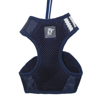 Navy blue soft step-in dog harness with textured mesh, D-ring patch, and padded leg openings.