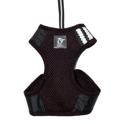 Black soft step-in dog harness with textured mesh, D-ring patch, and padded leg openings.