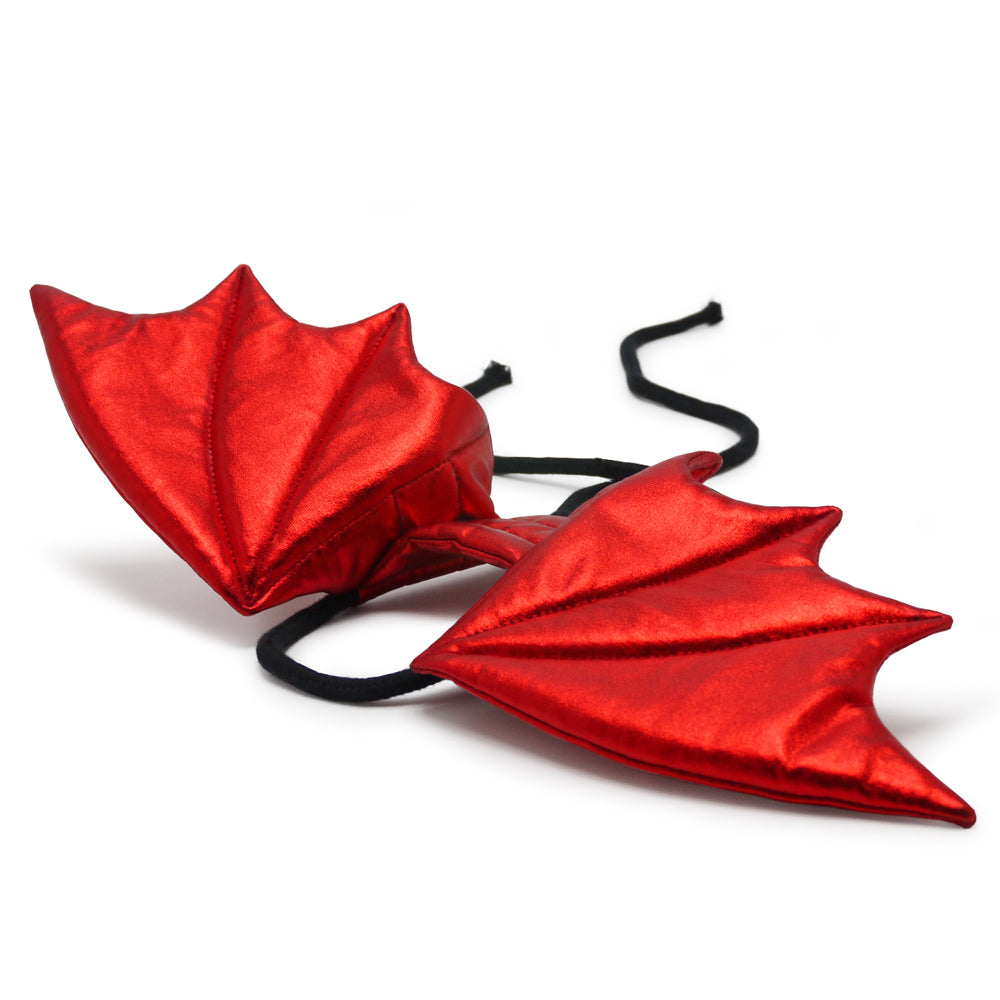 Red dragon wing pet costume with black straps, laid flat