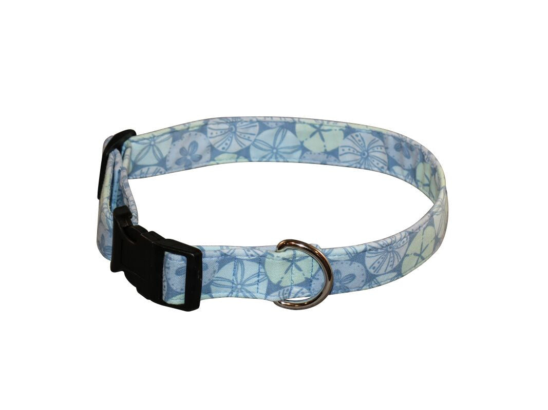 Blue patterned dog collar with sand-dollar print, black buckle, metal D-ring.