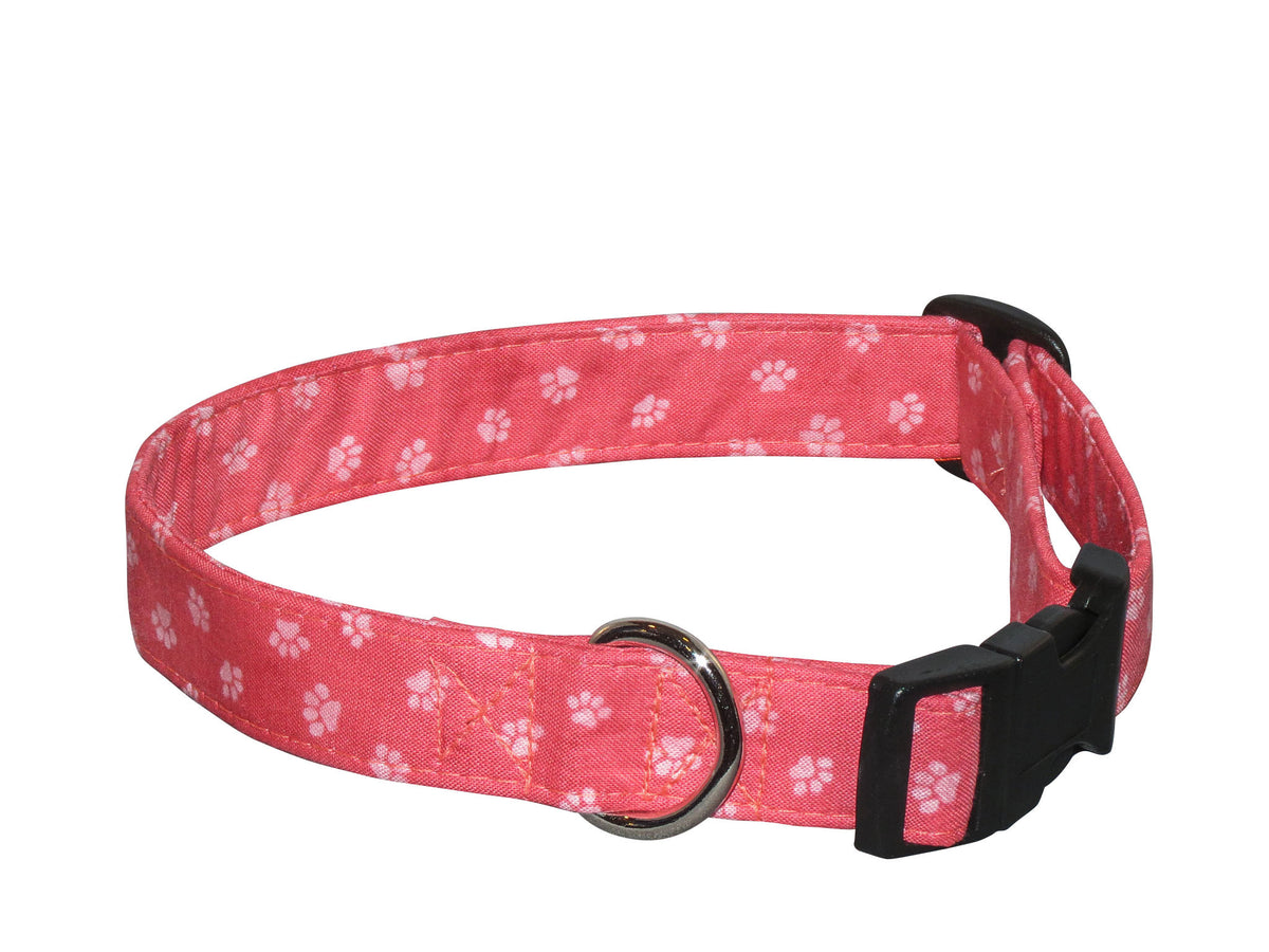 Pink paw-print dog collar with black buckle and metal ring