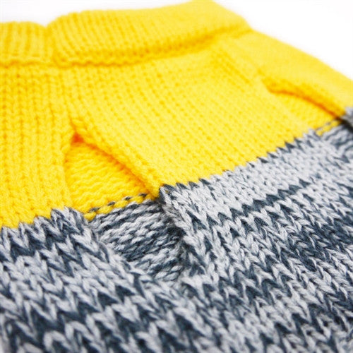 Close-up knit texture: bright yellow top with gray striping along the seam