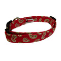 Christmas bandana dog collar with red fabric and green paisley pattern, adjustable clasp.