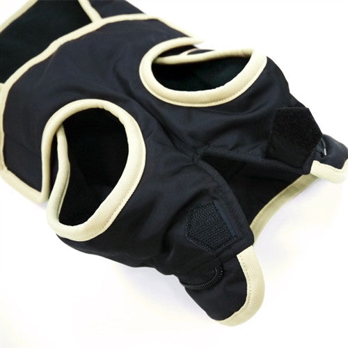 Dog trench-style coat detail: black sleeves, light trim edges, and arm opening