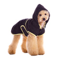 Dog trench-style coat with hood, black fabric and light trim, dog wearing front view