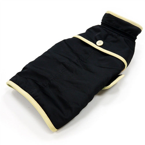 Black dog trench coat with tan trim, buttoned collar, and cape-style back