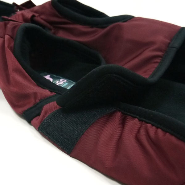 Maroon dog trench coat inner lining and adjustable strap, close-up of shoulder area