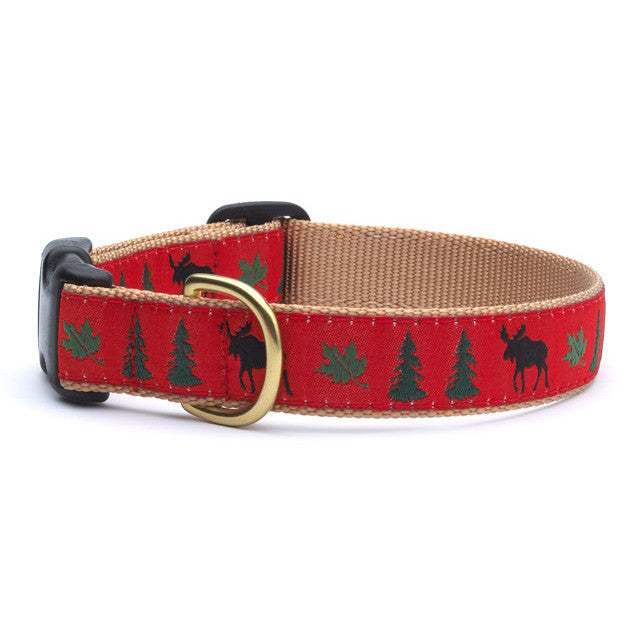 Moose-themed dog collar with red fabric, green pine trees, and brass buckle
